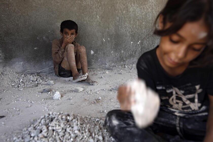 Palestinians make graves from the rubble of Gaza's destroyed homes